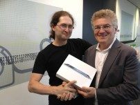 Yan Shvartzshnaider receiving his iPad (courtesy of Optus) for the Audience Prize from Dean Economou